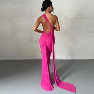 Macro detail of the backless cut and pink pleated fabric of this elegant floor-length dress
