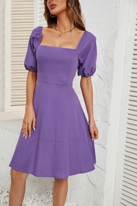 Detail view of the purple square neck dress showing puffed sleeves and waist stitching