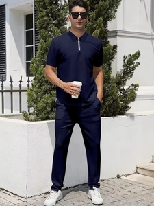 Detail of dark blue men's polo shirt zipper collar and slim fit athletic trousers