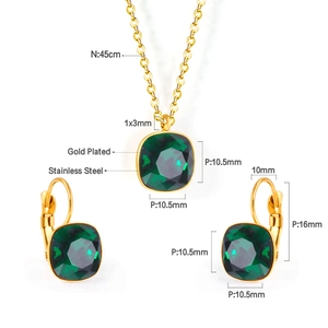 Detail view of gold-plated stainless steel jewelry set with square green crystals