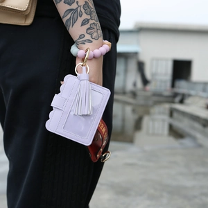 Silicone bead keychain bracelet with purple PU leather card holder and tassel detail