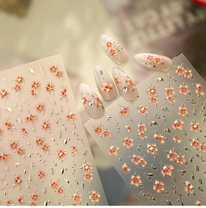 Detail of embossed floral nail stickers with gold leaves and pearl accents TL449