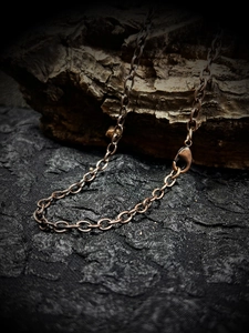 Vintage bronze metal O-link chain necklace with lobster clasp on rustic bark
