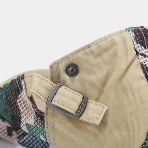 Macro detail of khaki mesh cap featuring adjustable metal buckle with GSIOR engraving