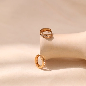 Close-up of 18K gold plated hoop earrings featuring sparkling pave set cubic zirconia crystals