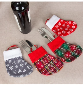 Close-up of festive cutlery holders in mini Christmas stocking shapes with snowflake patterns