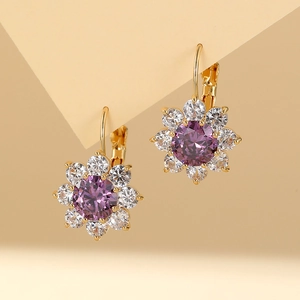 Elegant gold flower earrings featuring purple center stone and sparkling white crystals