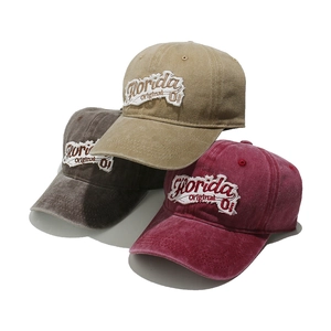 Detailed macro of washed cotton baseball caps with Florida embroidery in three colors
