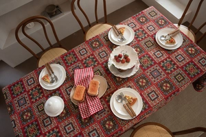 Detailed close-up of red Christmas jacquard tablecloth with festive geometric patterns