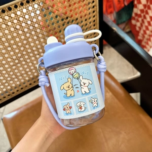 Close-up of a purple plastic water bottle with a cute dog cartoon leather sleeve and strap