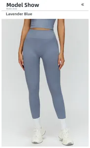 Detail of high-waisted compression leggings and sports top in elegant aster blue fabric