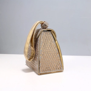 Luxury gold evening handbag with shimmering rhinestones and a stylish ball clasp