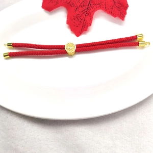 Detail of red Milan cord bracelet with 18k gold plated beads and adjustable slider buckle