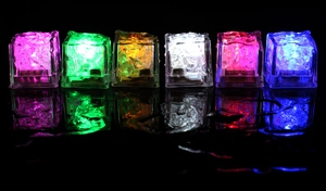 Detailed view of colorful LED ice cubes with cracked texture on a reflective surface