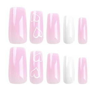 Pink and white gradient square press-on nails with heart patterns on white background