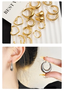 Macro detail of gold heart earrings and bamboo texture hoops on a white display card