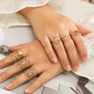 Set of 9 gold-plated stainless steel rings with heart and star patterns on hands