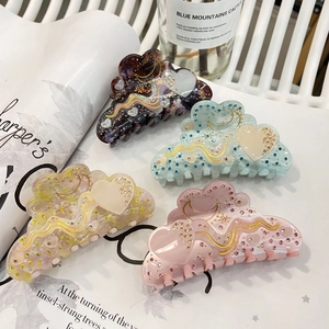 Cloud-shaped acetate hair claws with moon and star rhinestones in various pastel colors
