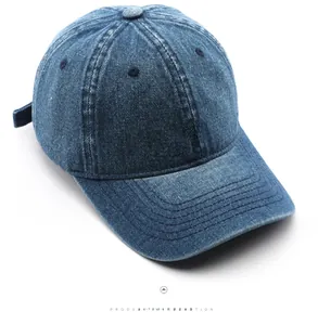 Detailed close-up of vintage washed denim baseball cap with red embroidered W letter