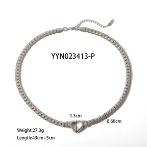 Silver stainless steel Cuban chain necklace with hollow heart pendant on white background