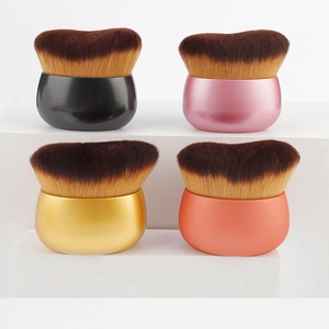 Macro view of dense dual-tone bristles and ergonomic metallic handles for foundation brushes