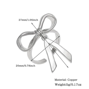 Detail view of silver bow ring with dimensions 27mm and copper material specifications