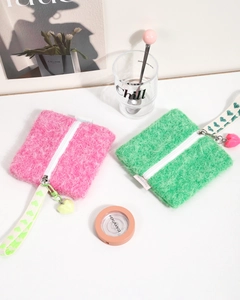 Close-up of fuzzy square mini pouches with heart pendant and heart print wristlet