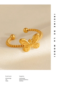Detailed close-up of 18K gold plated butterfly ring with twisted rope band design