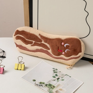 Detail of plush bacon pencil case with cute embroidered smile and soft texture