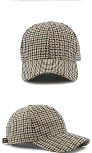 Close-up of retro houndstooth pattern texture and woven fabric on baseball cap detail