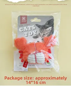 Detailed close-up of orange plush crab cat toy in sealed packaging with backing card