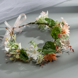Close-up of floral bridal headband with peach roses and soft pink organza ribbon