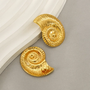 Vintage 18K gold plated seashell spiral earrings in a 45-degree artistic display