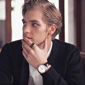 Minimalist matte black stainless steel ring for men showcased on model's index finger
