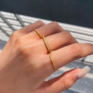 Multilayered gold plated stainless steel multi-finger ring with pavé set zircon stones