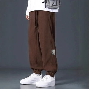 Men's dark brown corduroy cargo pants with elastic waist and relaxed fit design