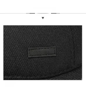Detailed macro view of the black twill fabric and textured SPORT rubber label on the cap