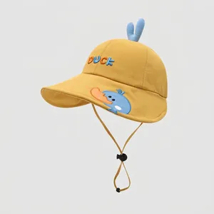Detail of yellow cotton duck hat for kids showing embroidery and adjustable wind rope