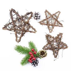 Flat lay of handmade rattan stars, frosted pine cones, and red berries for DIY crafts