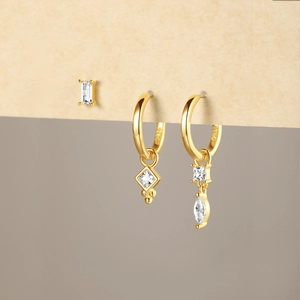 Detailed macro view of S925 sterling silver gold earrings set with zircon pendants