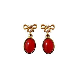Vintage gold bow earrings with red resin oval gems and elegant hanging pearls