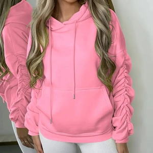 Detailed shot of pink hoodie featuring ruched sleeves and classic kangaroo pocket