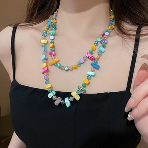 Détail d'un collier bohème à plusieurs rangs avec perles de verre et coquillages