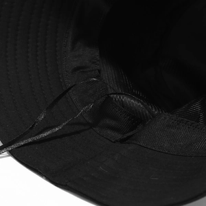 Black bucket hat with heart embroidery showing adjustable inner strap and breathable lining