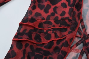 Close-up of leopard print mesh fabric with ruffled edges and red black pattern details