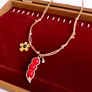 Vintage necklace with red zircon flower pendant and brown cord in luxury jewelry box