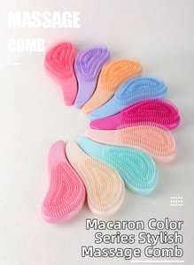 Macro display of pastel massage combs with ergonomic design and flexible bristles