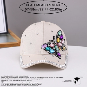 Detail of butterfly embroidery with colorful rhinestones on a beige baseball cap