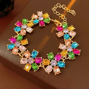 Vintage style gold bracelet with colorful oval gemstones and flower petals design