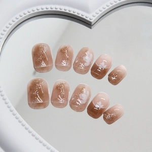 Short round amber marble press-on nails with white floral designs and silver glitter accents